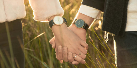 Couple holding hands with watches on opposite wrists