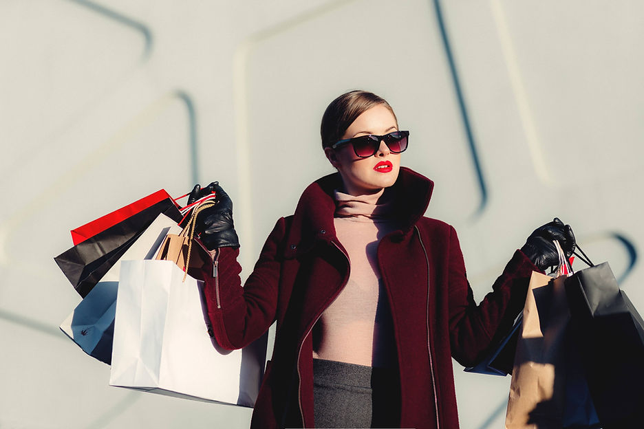 fashion conscious lady holding many bags of shopping