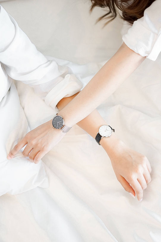 Simplistic fashion - man and woman wearing minimalist watches and watch straps