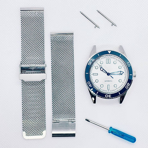 Watch and milanese loop strap laid out to start strap install