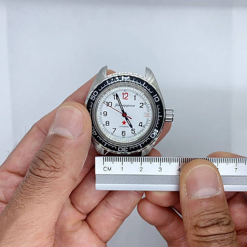 Measuring the lug width of the watch with a ruler