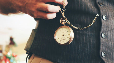 Pocket Watch on Chain Held By Man Wearing Waistcoat