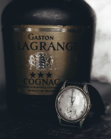 Vintage Watch With Cognac Bottle