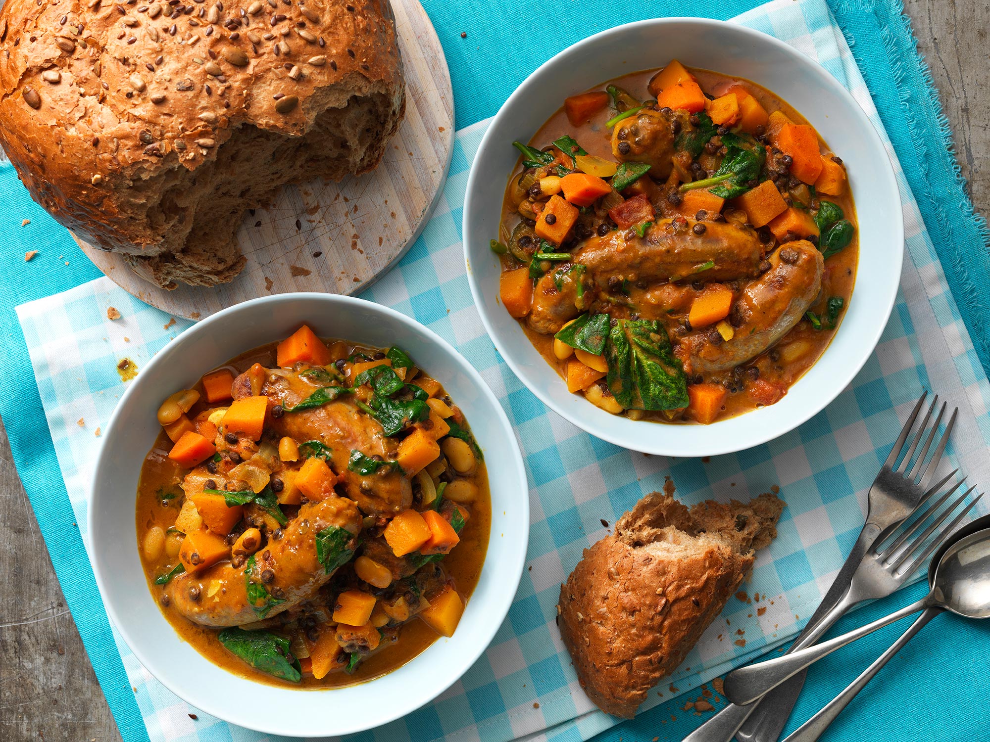 sausage and squash in bowls with bread