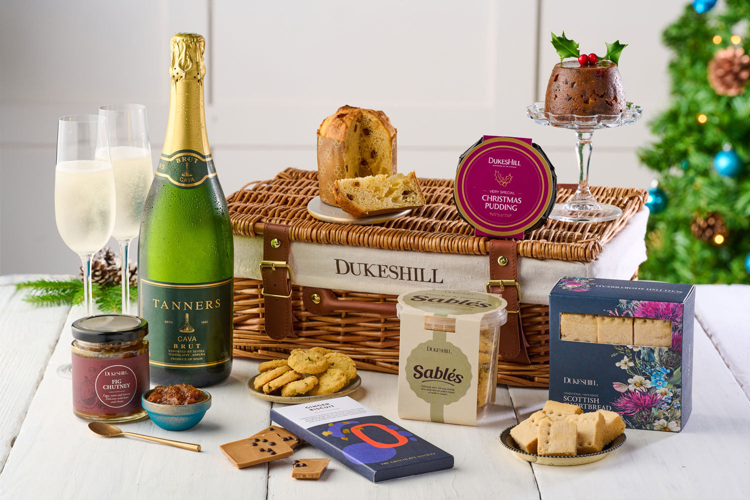 wicker hamper with bottle of cava and sweet food