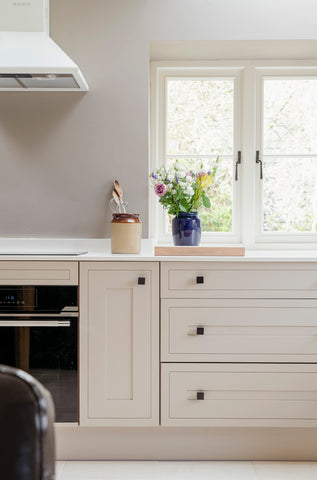 From The Anvil's Matt Black Albers cabinet knobs on cream kitchen cupboards and drawers