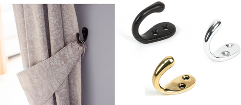 From The Anvil's Black Celtic Single Robe hook used to hang a curtain tieback, next to three product images of the same hook in Brass, Chrome, and Black finishes.