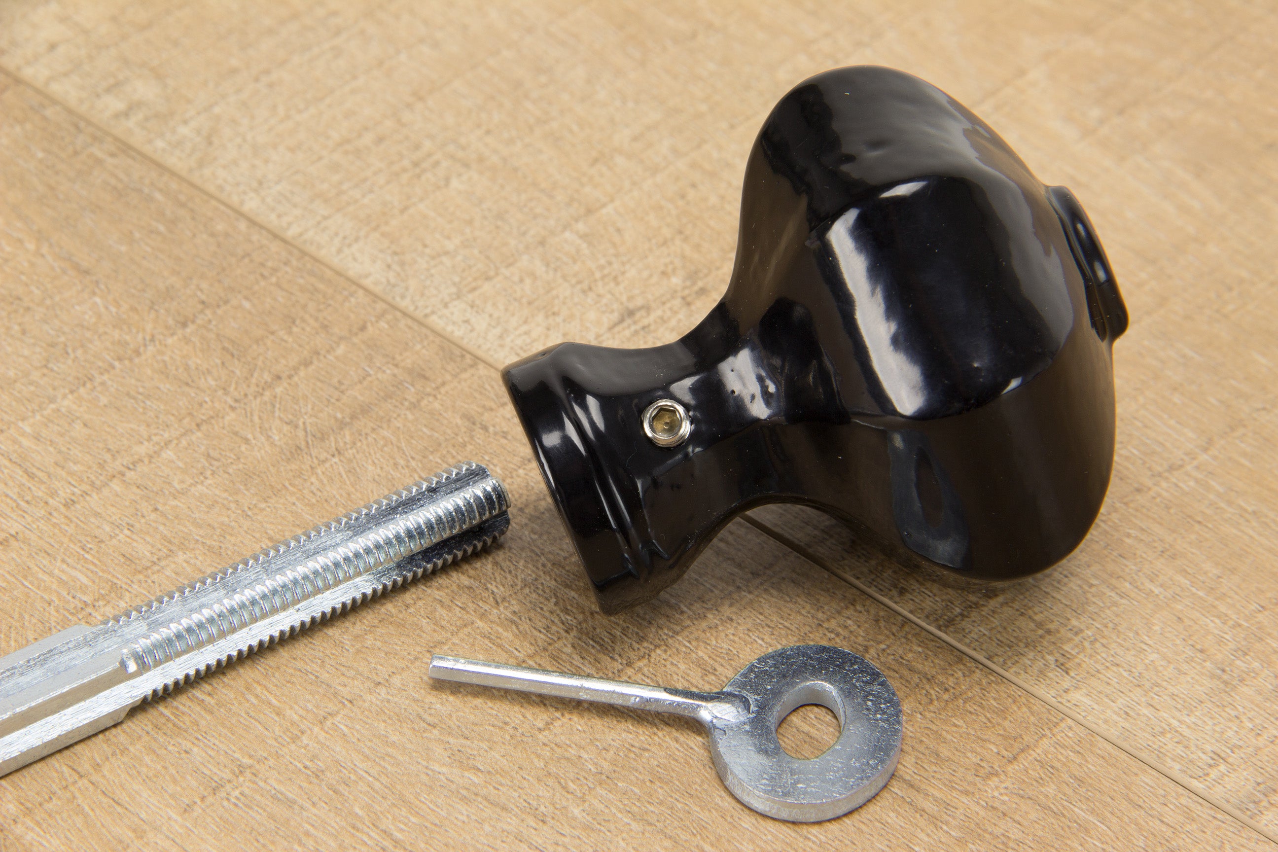 A Black Octagonal knob with a spindle and Allen key.