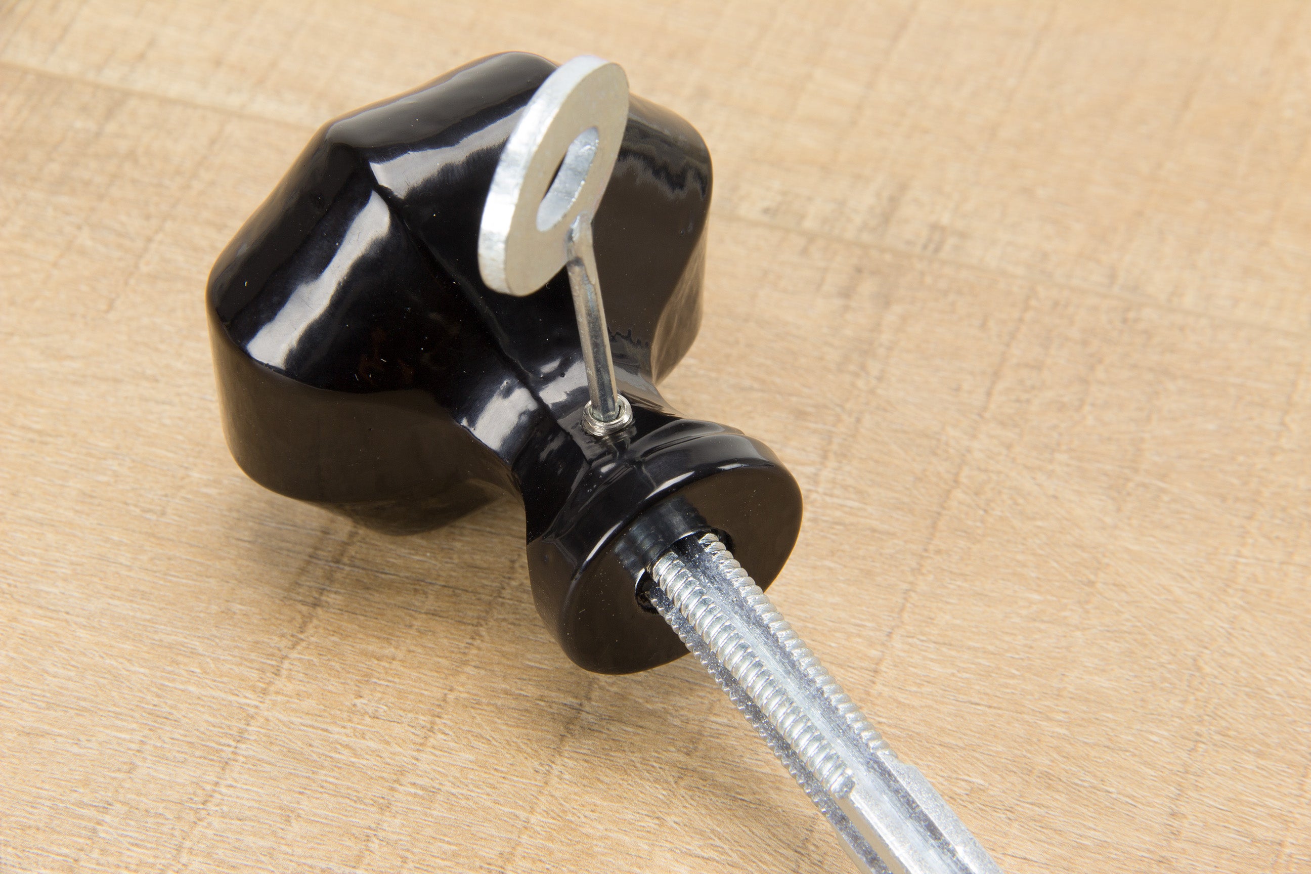 Person using an Allen key to tighten a grub screw on a Black Octagonal knob to secure it to the spindle.
