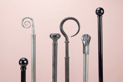 From The Anvil curtain finials on curtain poles in Pewter, Beeswax, and Black finishes.