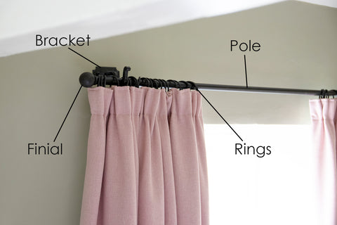 Pink pleated curtain on From The Anvil's Beeswax curtain pole, curtain rings, curtain bracket, and round ball curtain finials.