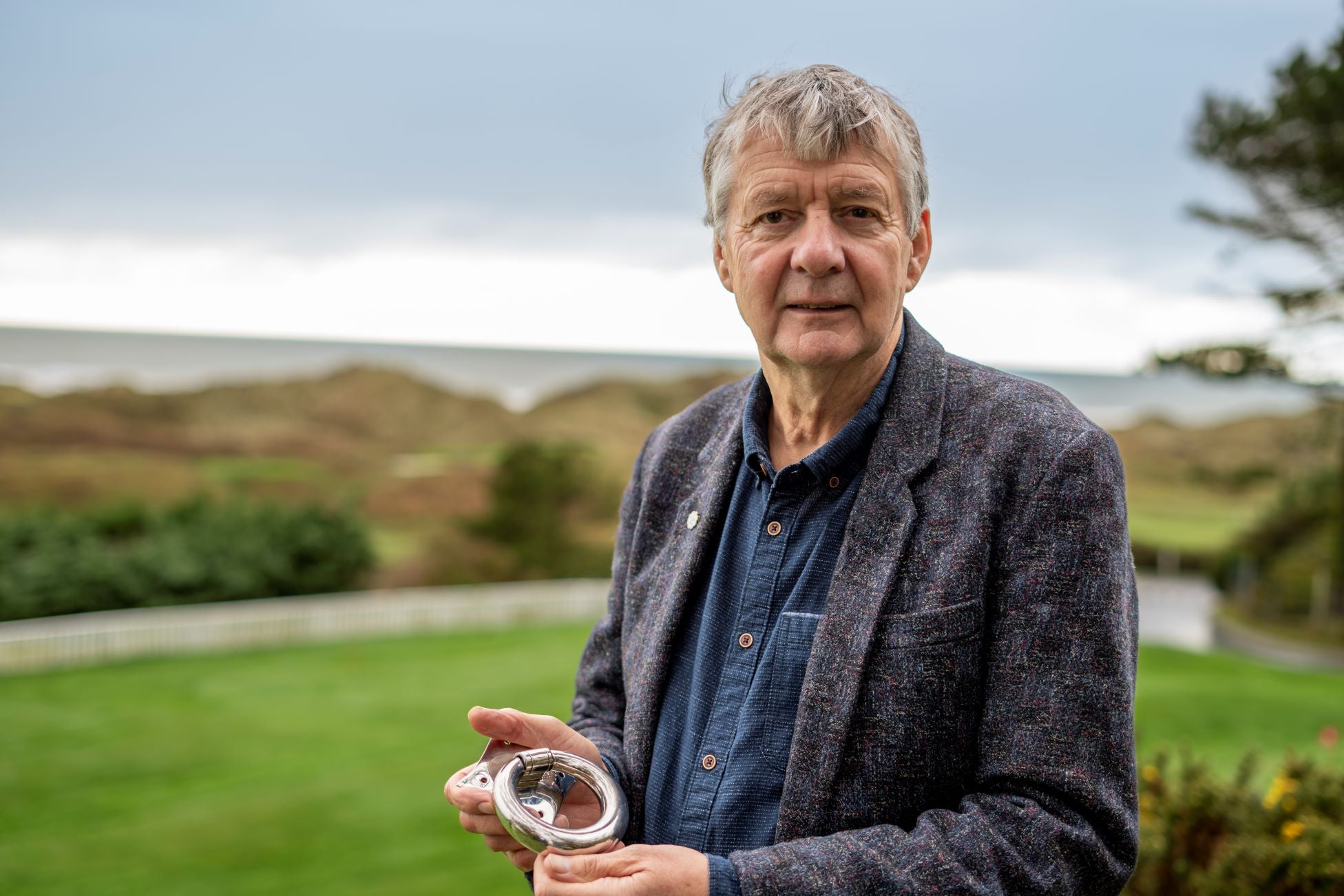 From The Anvil founder Mark Underhill holding a Polished Marine Stainless Steel Ring door knocker.