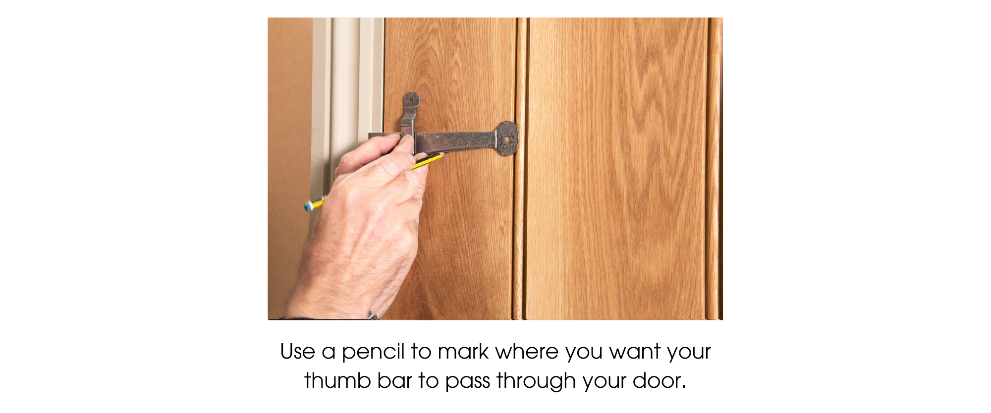 Person using a pencil to mark the underside of a latch bar on a ledge & brace door to mark the position at which the thumb bar should be fitted.