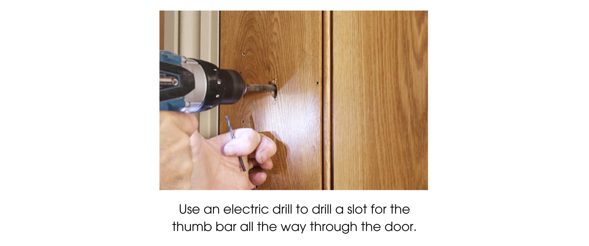 Person using an electric drill to drill a hole in a ledge and brace door to fit the thumb bar part of a thumb latch.