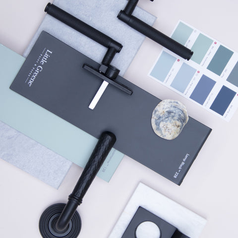 A moodboard of From The Anvil's Matt Black hardware against Little Greene's pale blue and black paints and white marble slabs.
