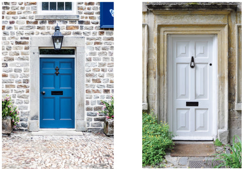 Left: blue door on a brick wall with a Black letter plate, door knob, and knocker, and a Black light overhead. Right: white door with stone frame, and a Black loop door knocker and matching letter plate.