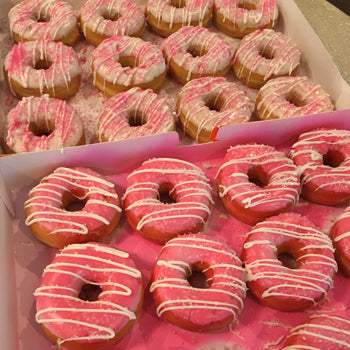 Plain White Glazed Donuts with Drizzled Candy Melts and Sugar Crystals