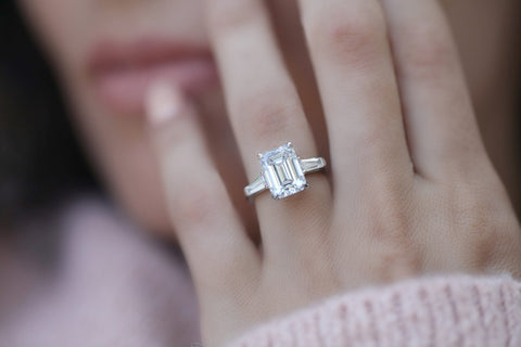 Girl wear emerald cut engagement ring