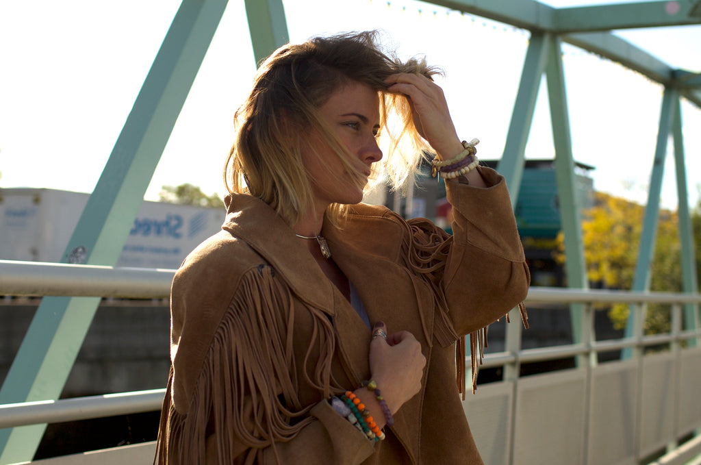 girl on bridge in fringe suede boho jacket and jewelry