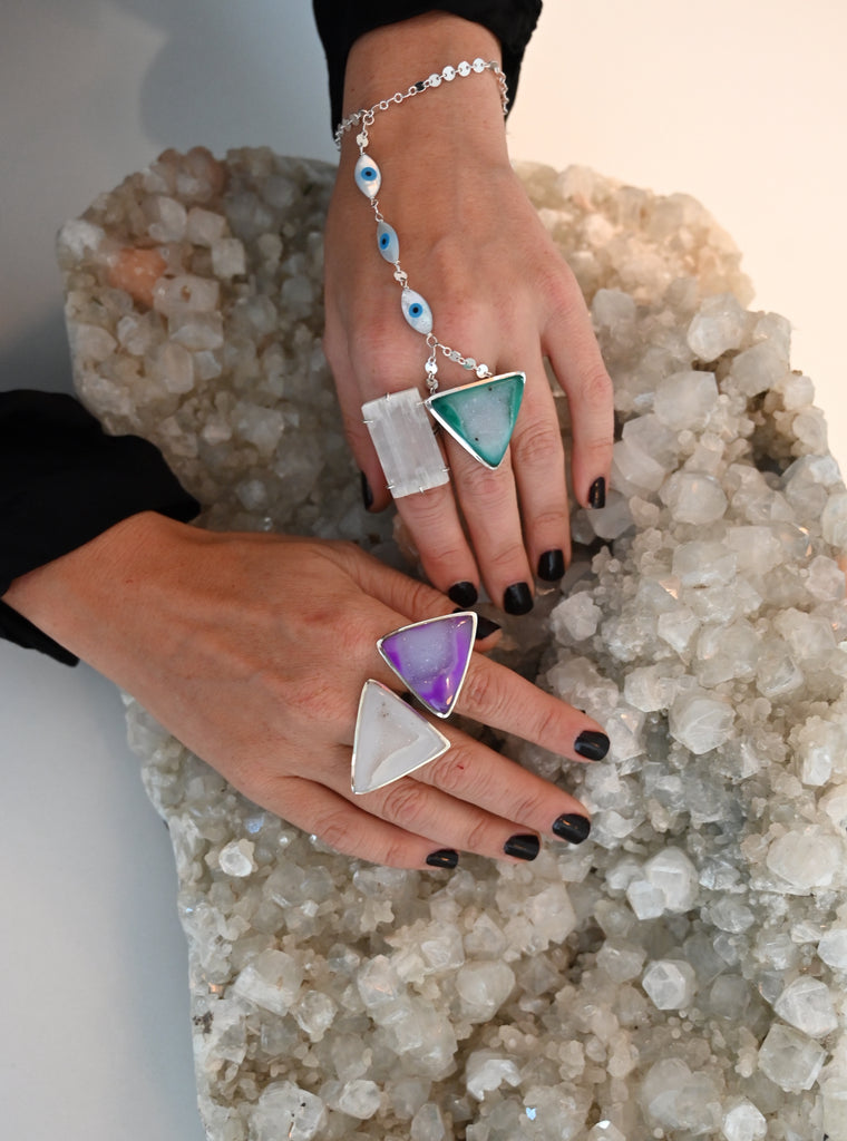 crystal geode rings fierce forward with hands on top of large gemstone