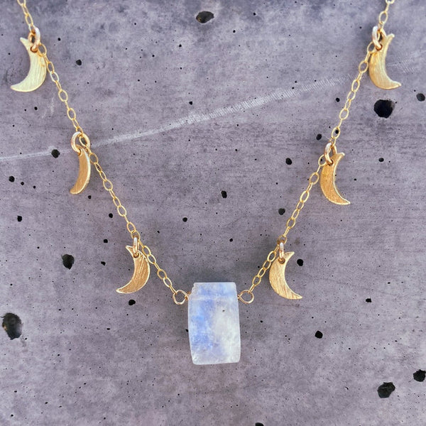 Gold moonstone choker necklace with small moon charms and a rectangular moonstone pendant. 