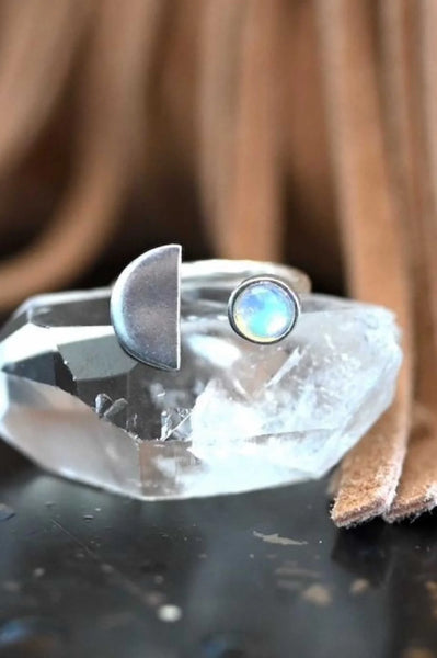 Adjustable moonstone ring has a silver half moon on one side and a small, circular moonstone on the other