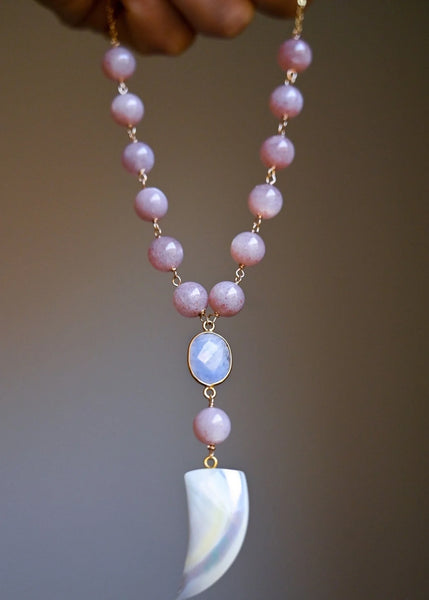 Choker necklace with peach moonstone beads, a moonstone gemstone, and a large mother of pearl horn pendant.
