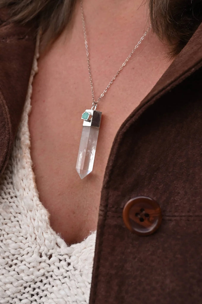 Woman wearing clear quartz crystal pendant for self love