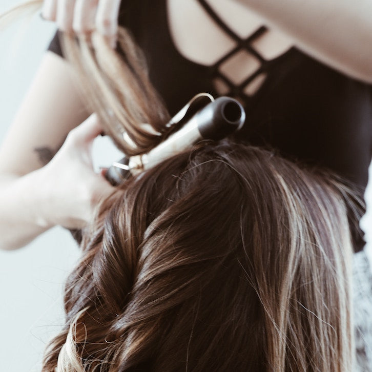 girl-straightening-hair