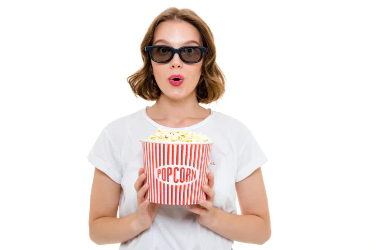 An image of a girl holding a popcorn bucket in her hand 