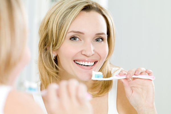 A woman brushing her teeth