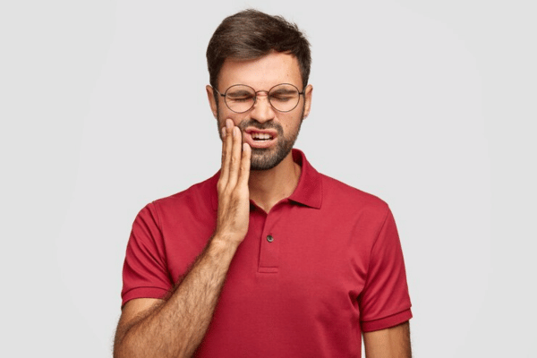 Man feeling irritation in gums