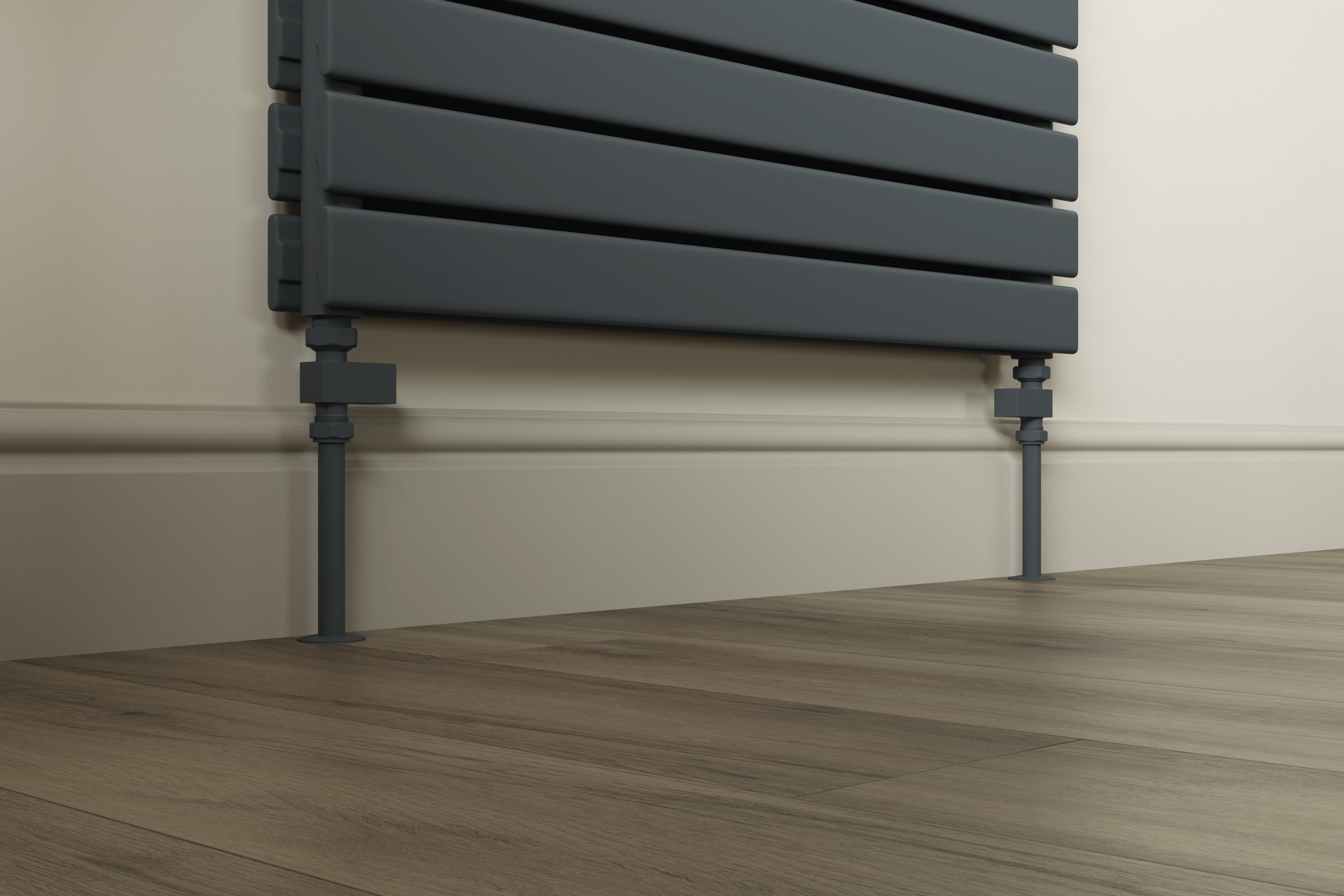 An anthracite grey flat panel radiator with perfectly matching pipe covers in a minimalist room.