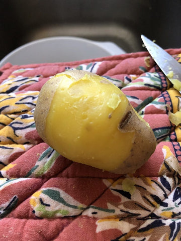 peeled potato on a hot pad