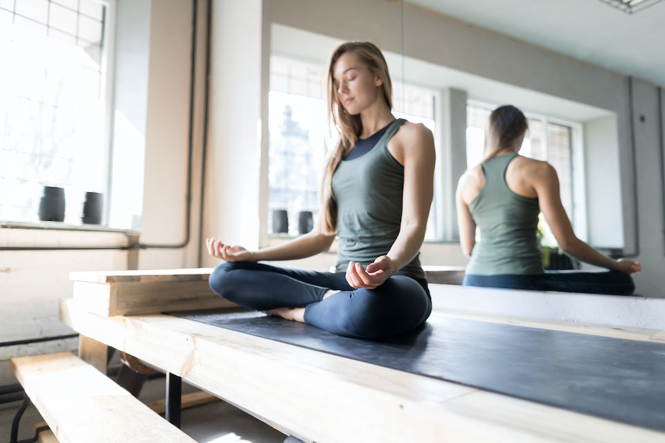 Woman meditating in yoga studio 