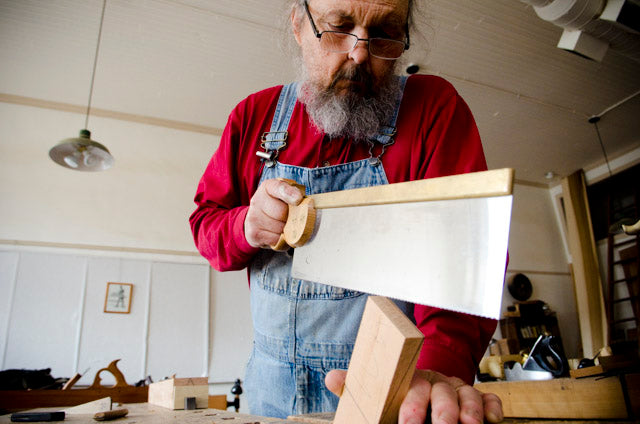 Bill Anderson using a tenon saw while making a wooden bench plane at Roy Underhill's Woodwright's School