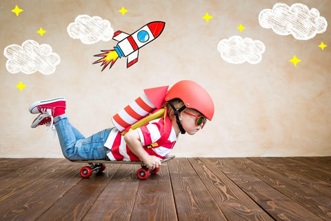 A helmeted young boy confidently skateboards, showcasing his passion and skills