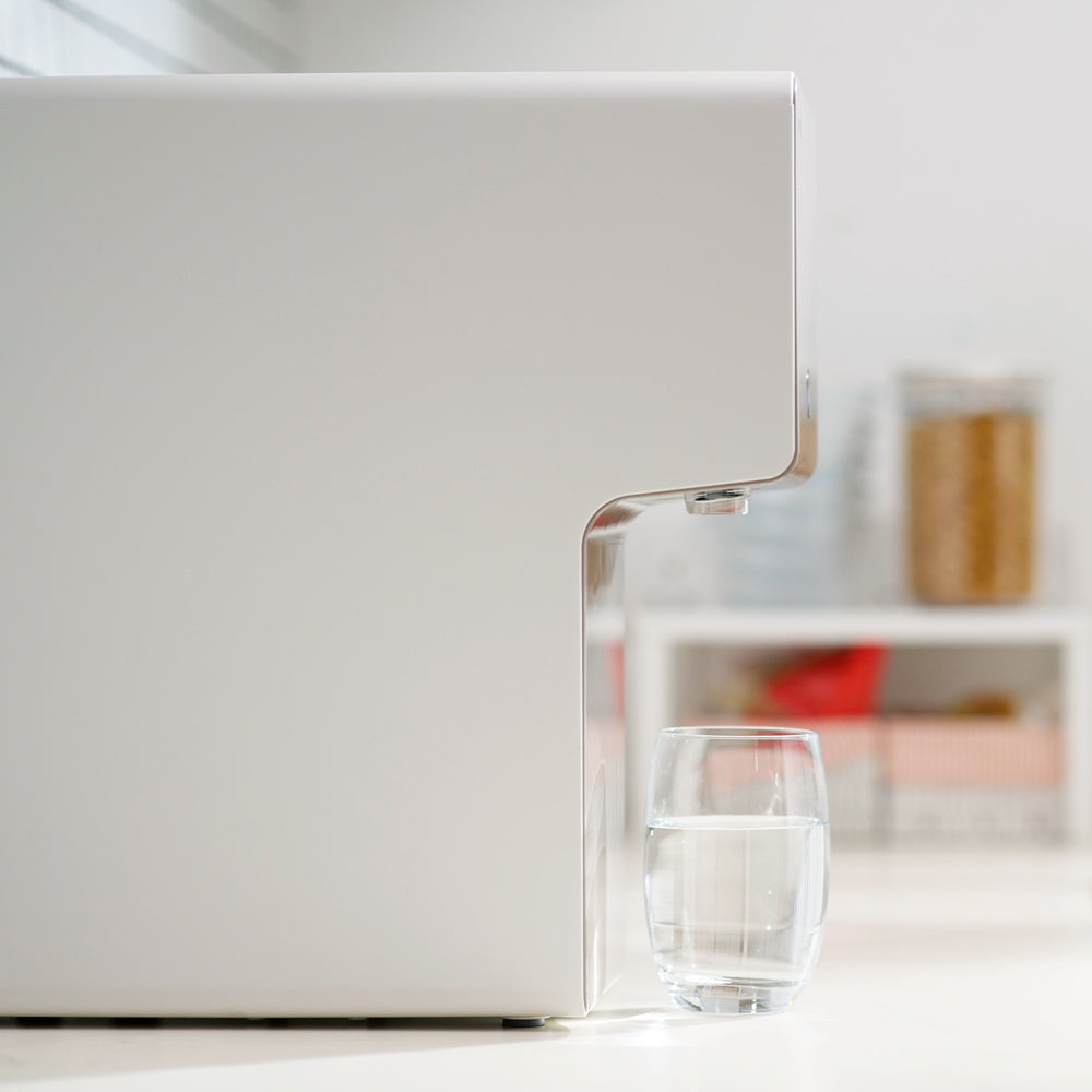 left-view-of-home-water-purifier-with-a-cup-of-250ml-of-water-coway-cinnamon.jpg__PID:1b8069b0-baea-47d1-9225-8170f4137456