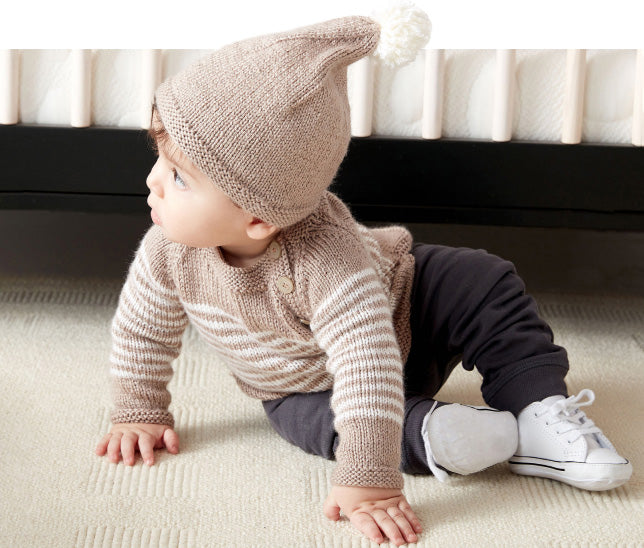 Baby wearing cardigan and hat