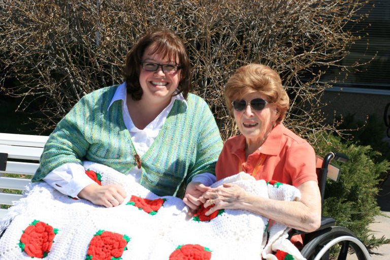 Marly Bird and her Grandmother with a white afghan