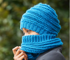 Women wearing blue balaclava and holding it from one hand