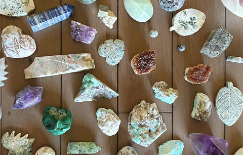 Wood table with an assortment of different types of crystal specimens