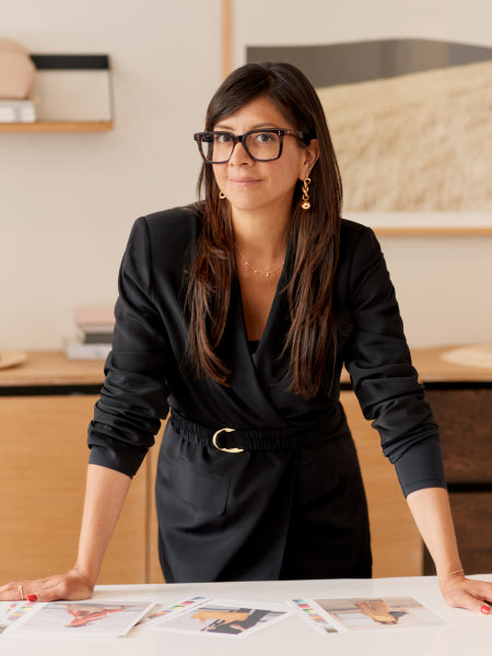 Karla Gallardo, CEO Of Cuyana, standing behind a design table