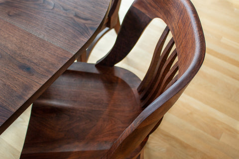 Close up image of Western Walnut Banjo chair by The Joinery at Jost Dining Table