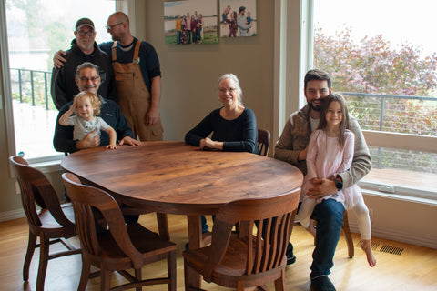 Shannon and Jalal at their Western Walnut dining set by The Joinery with additional family and Joinery finish team.