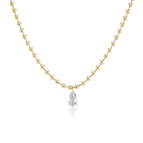 Yellow gold ball chain necklace with pear cut white diamond drop.