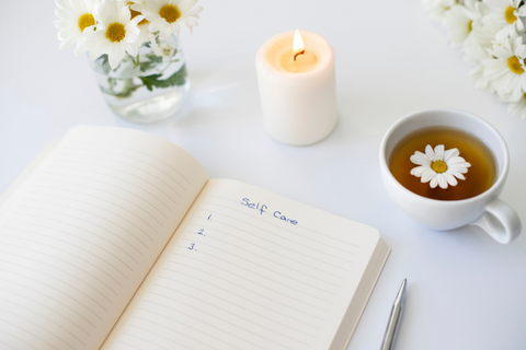 self care image with notebook and tea