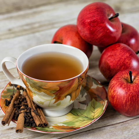 A cozy cup of Cinnamon Apple Tea with fresh apple slices and a hint of cinnamon.