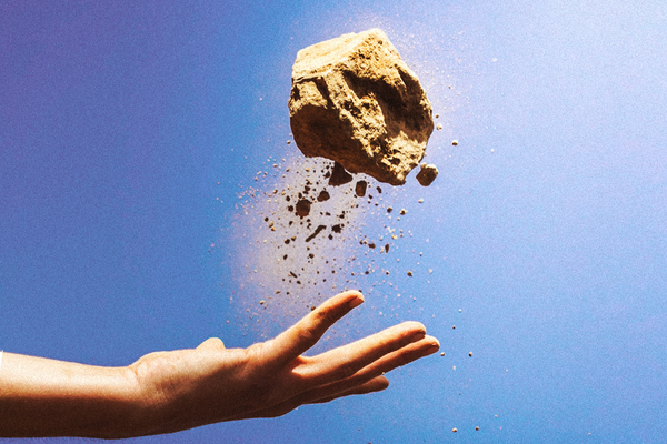 A hand tossing a moon rock