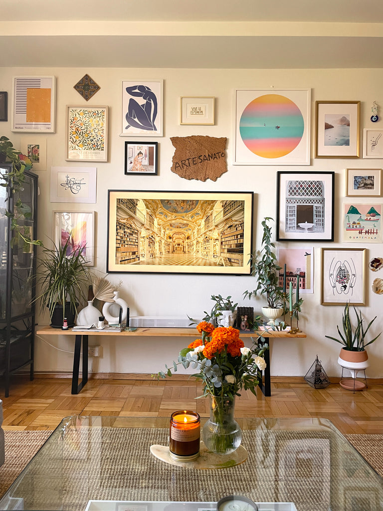 A modern apartment gallery wall with a clear coffee table